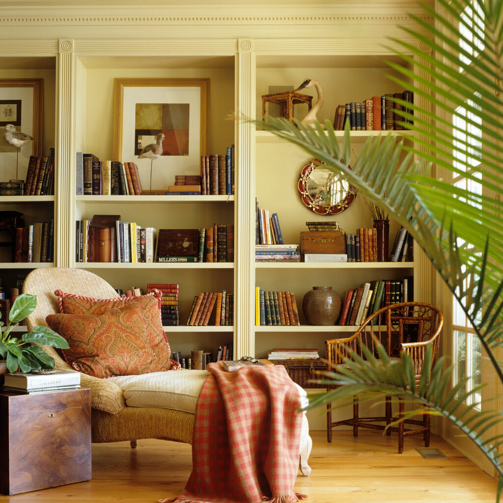 A sumptuous living room with prominent bookshelves.