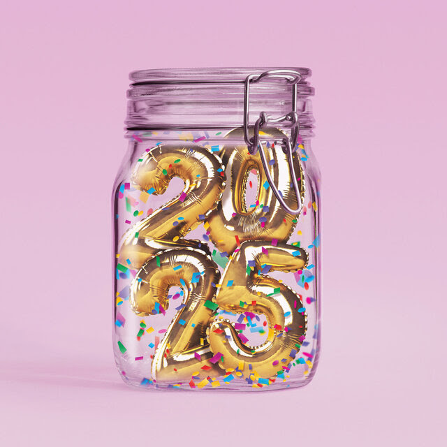 A photo illustration of a clear kitchen jar with the gold balloon numbers "2025" and colorful confetti inside. The background is pink. 