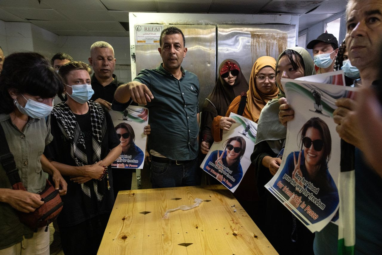 Palestinians and international activists inside the morgue Sunday where the body of slain Turkish American activist Aysenur Eygi is being kept, in Nablus in the occupied West Bank. (Heidi Levine for The Washington Post/FTWP)