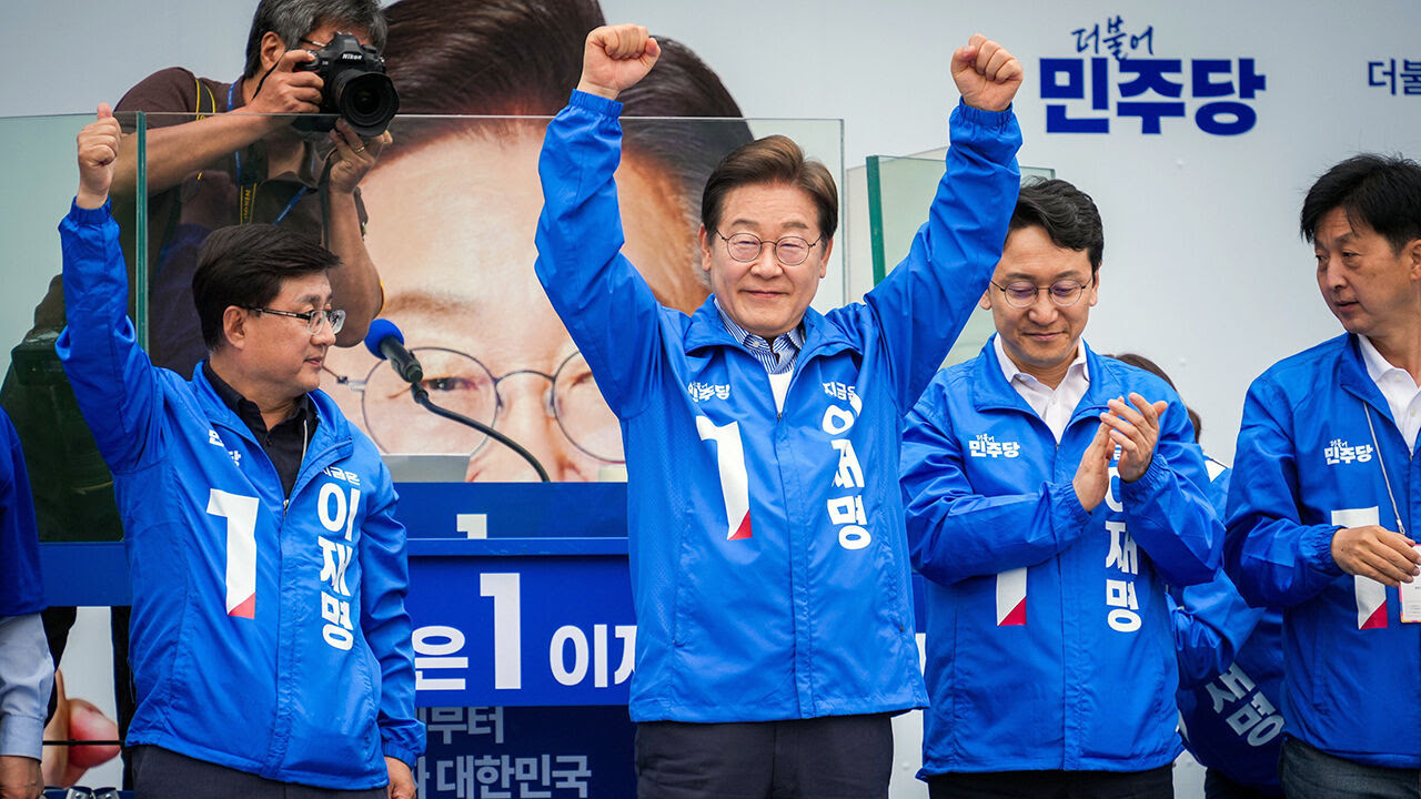 Lee Jae-myung raises his arms as he is applauded at a campaign rally in Seoul, South Korea
