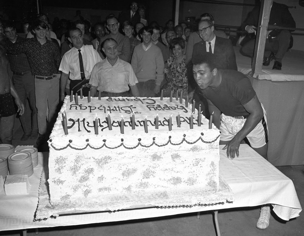 FILE - In this Jan. 17, 1967 file photo, Muhammad Ali blows out the candles on a cake baked for his 25th birthday, in Houston. Ali's wife says the boxing great is still a "big kid" who enjoys his birthday parties. The three-time heavyweight champion turns 70 Tuesday, Jan. 17, 2012. He will be surrounded by friends Saturday night for a birthday party at the Muhammad Ali Center in his hometown. (AP Photo/Ed Kolenovsky, File)