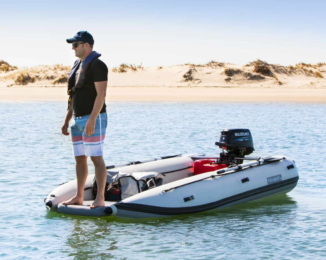 Man standing on a Takacat Boat