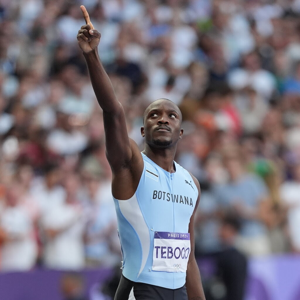 Letsile Tebogo with a raised arm after winning the 200 meter race. 