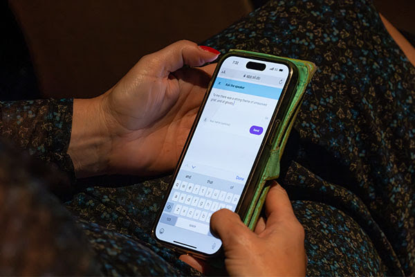 A woman holding her phone in her lap