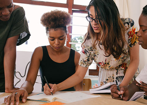 An expert confidently explaining a problem-solving technique to a group of attentive individuals