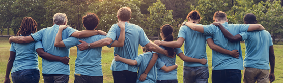 Back facing view of people wrapping arms around each other