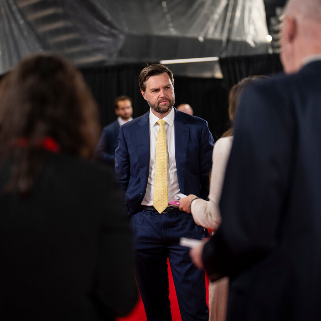 J.D. Vance standing onstage listening to someone at the Republican National Convention in Milwaukee.