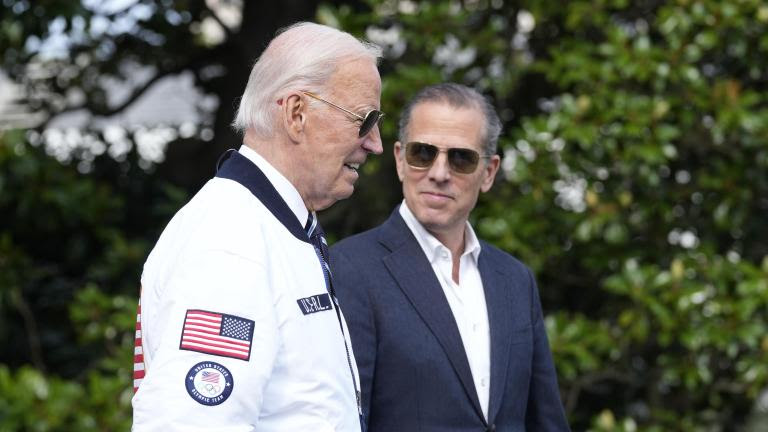 FILE - President Joe Biden, wearing a Team USA jacket and walking with his son Hunter Biden, heads toward Marine One on the South Lawn of the White House in Washington, July 26, 2024. (AP Photo/Susan Walsh, File)