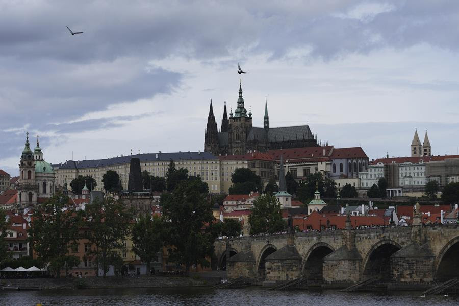 A landscape photo of the St. Vitus Cathedral in Prague and surrounding neighborhood.