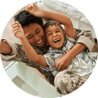 Happy mother wearing military uniform and her son lying on floor