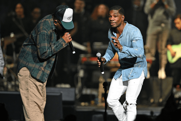 On left: a Black man sings into microphone wearing a hat, plaid shirt and khakis. On right: a Black man holds microphone wearing a denim shirt and white jeans. 