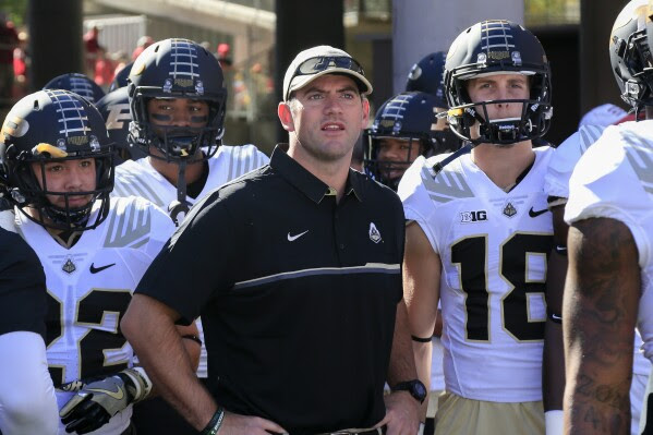 FILE - Then-Purdue interim coach Gerad Parker stands with players before the team's NCAA college football game against Nebraska in Lincoln, Neb., Oct. 22, 2016. Troy hired Notre Dame offensive coordinator Gerad Parker to be its next head coach on Monday, Dec. 18, 2023. Parker, 42, will replace Jon Sumrall, who left Troy earlier this month after two successful seasons to become head coach at Tulane. (AP Photo/Nati Harnik, File)