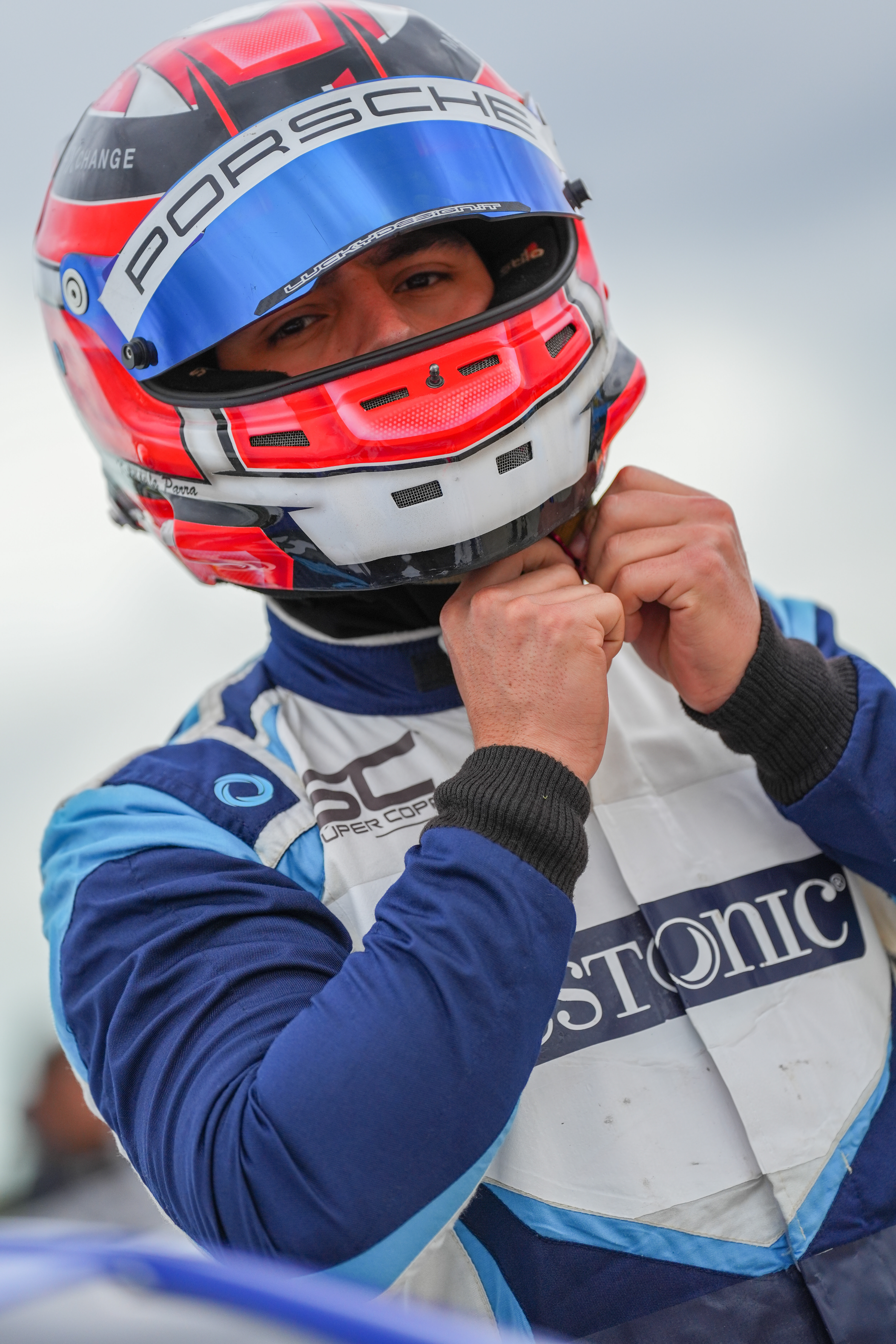 a man standing in front of a race car