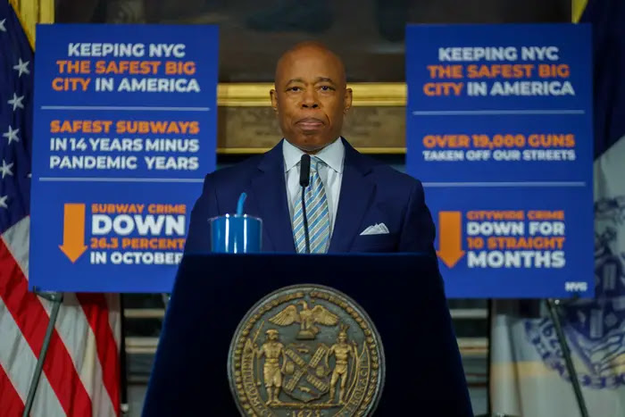 New York City Mayor Eric Adams stands at a podium.