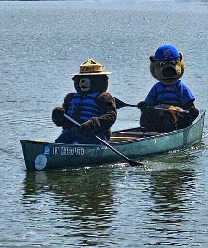 Cubby and Smokey the Bear in a canoe