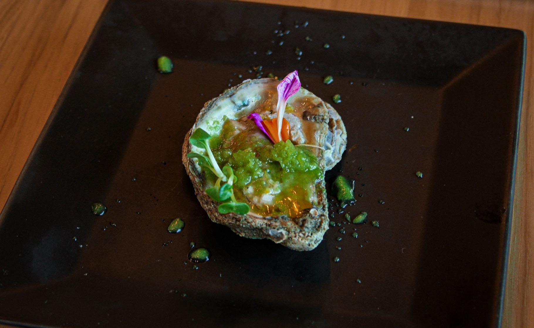 Pacific Gold Oyster with melon and shiso granita, preserved lemon vinaigrette, and mint. 