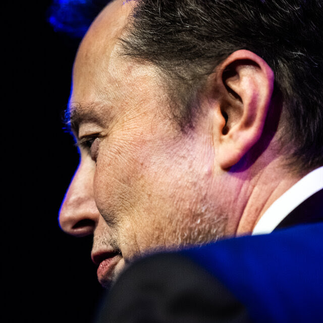 A side view of Elon Musk.