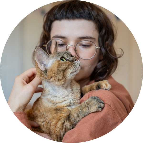 Photo of white woman with short brown hair holding a cat.