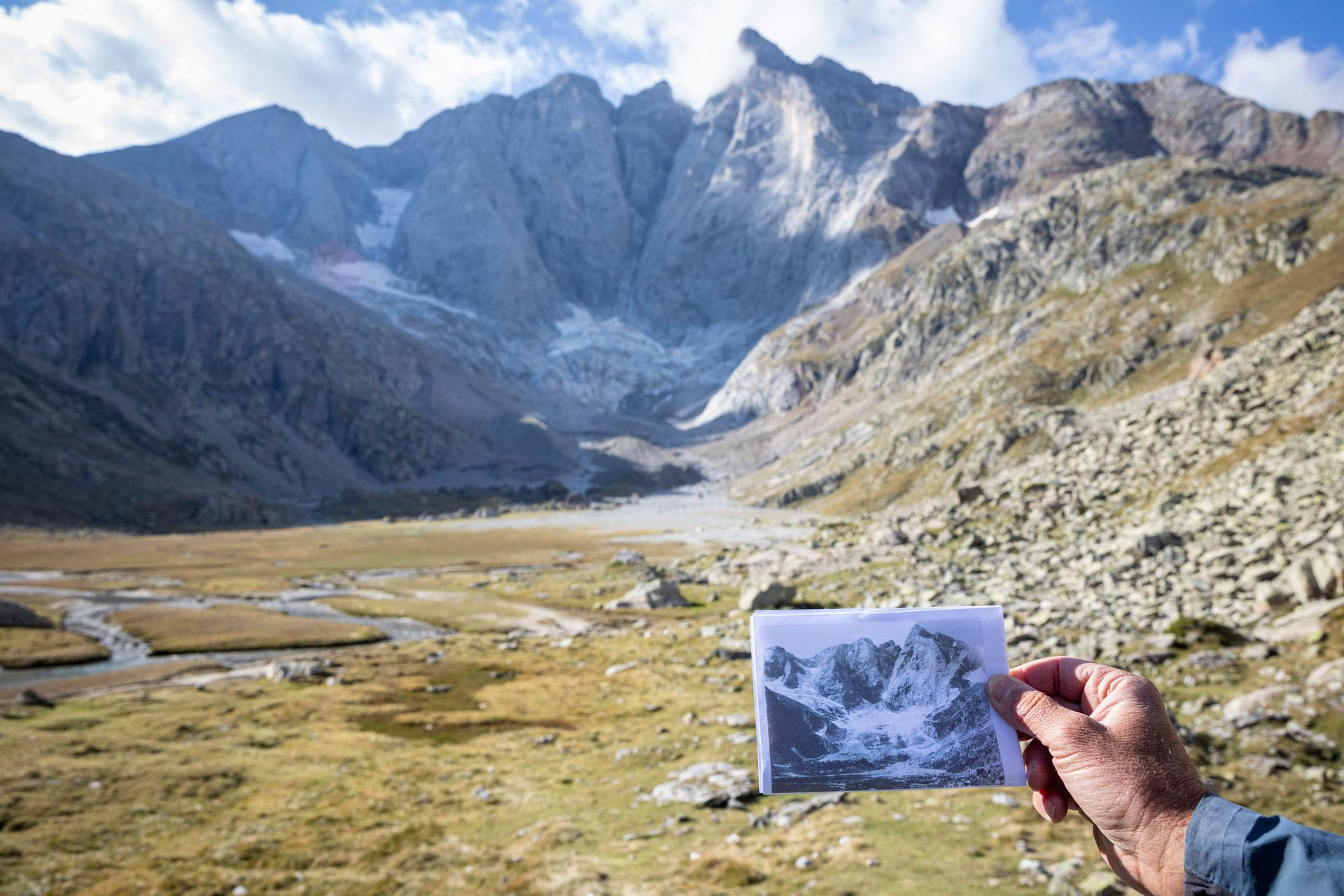 Le glaciologue Pierre René, face au glacier des Oulettes de Gaube, tient à la main une photo prise en 1904.