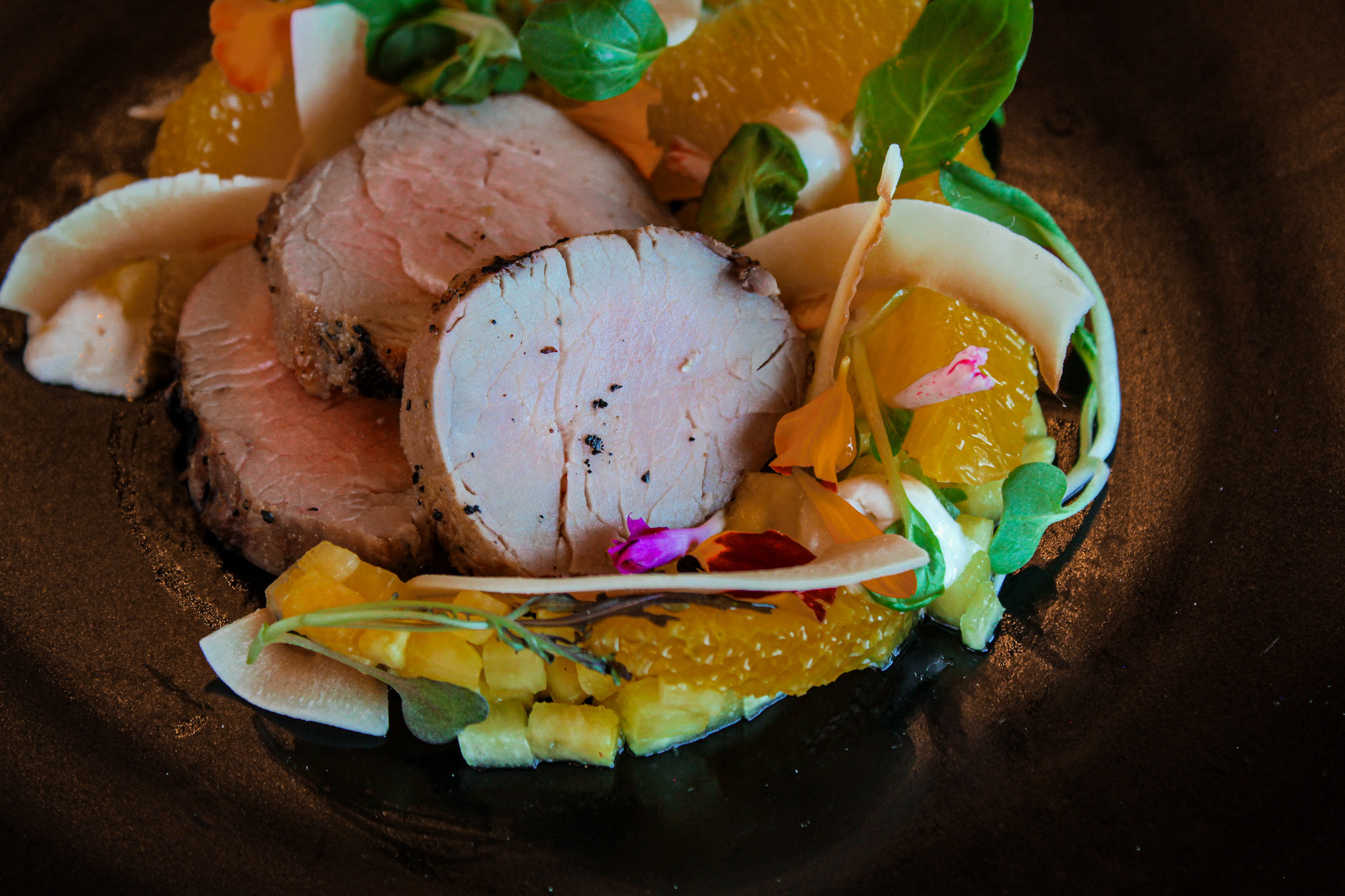 Pork tenderloin with Fuyu persimmon "ambrosia" salad, shio koji marshmallow, cured pineapple, and toasted coconut.