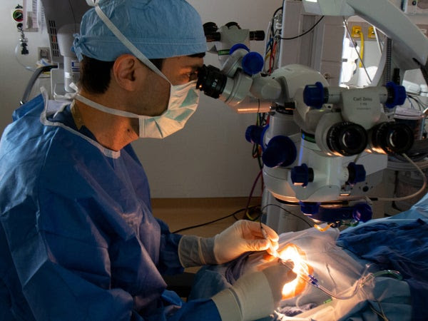 Jason Comander performs a surgical procedure to deliver CRISPR medicine to the cells of a patient's retina.