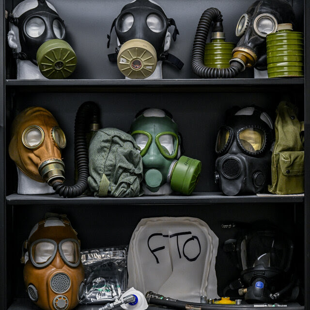 Shelves full of different kinds of gas masks.