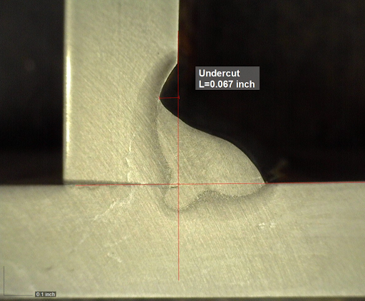 Excessive voltage may cause undercut as seen in this weld. The arc energy melts the base material but there is not enough filler metal to fill that void which then results in undercut.  Undercut is dangerous as it can significantly reduce the fatigue life of a welded connection.