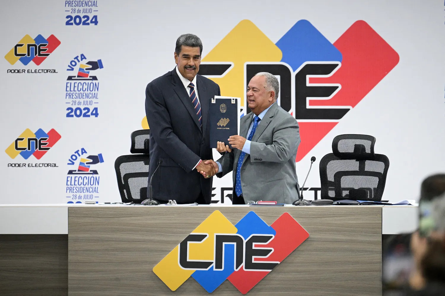 Venezuelan President Nicolás Maduro shakes hands with National Electoral Council President Elvis Amoroso in Caracas.