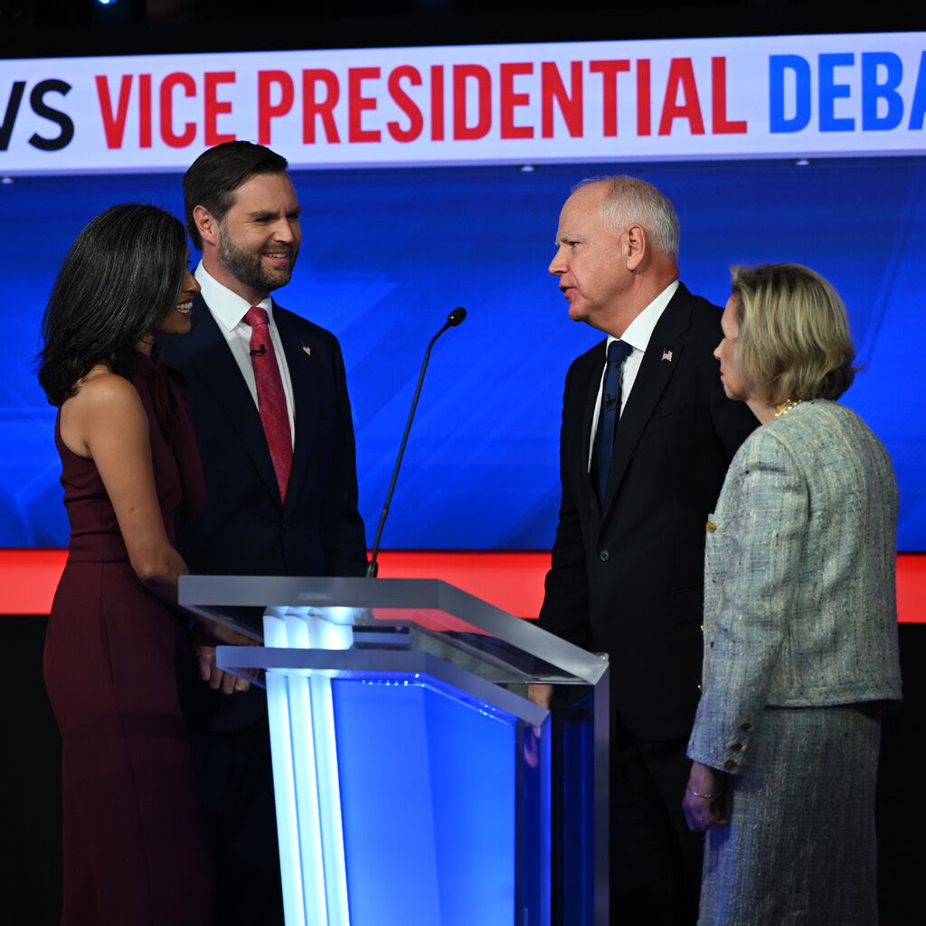 Mr. Vance with his wife, Usha Vance, and Mr. Walz with his wife, Gwen Walz, after the debate.