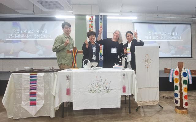 Reverend Kim Susannah (right) and members of the congregation welcome Emily Dwyer to Sumdol Hyanglin church.