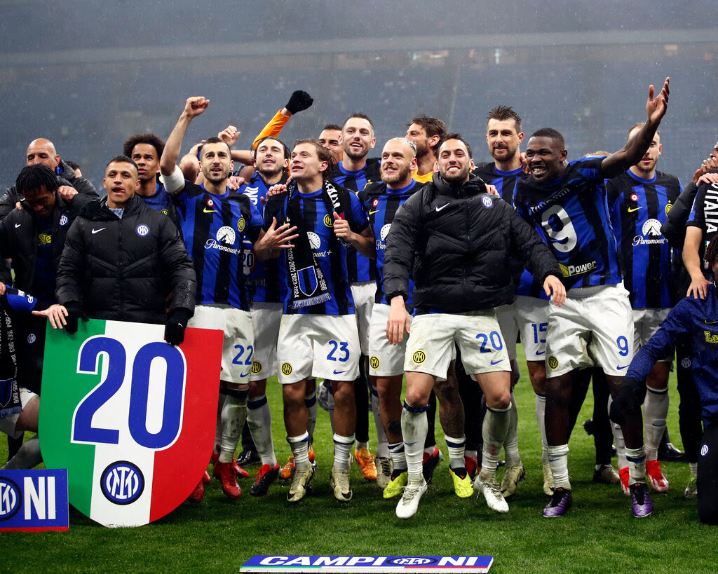 Soccer players from the Italian club Inter Milan jump and celebrate after winning a match.