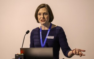 Woman standing at a podium speaking