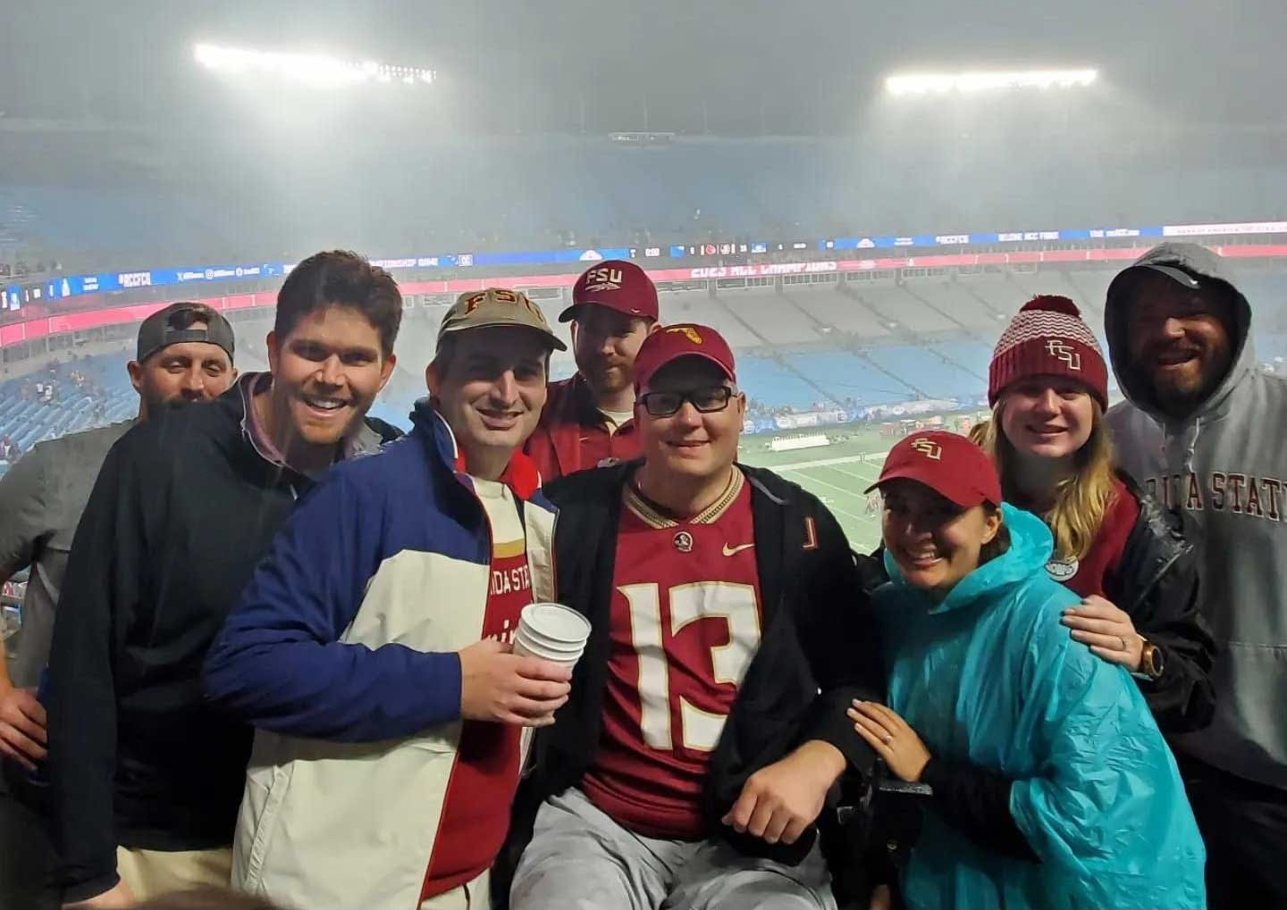 John and a group of friends at a college football game.