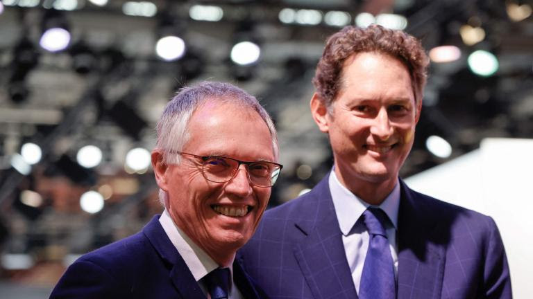 (FILES) Stellantis chairperson John Elkann (R) and Stellantis CEO Carlos Tavares (L) attend the Paris Motor Show at Paris Expo Porte de Versailles in Paris on October 14, 2024. Stellantis chief executive Carlos Tavares, 66, resigned on December 1, 2024 "with immediate effect", the auto giant announced, signalling differences over how to confront the group's profit slump. An "interim executive committee" led by chairman John Elkann will run the company until the appointment of a new permanent chief executive officer within the first half of 2025. (Photo by Ludovic MARIN / POOL / AFP)