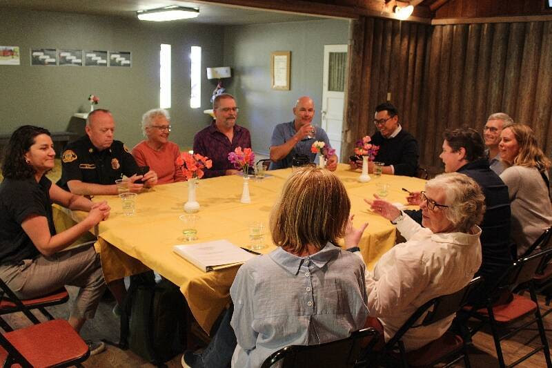 Several people sitting around a table