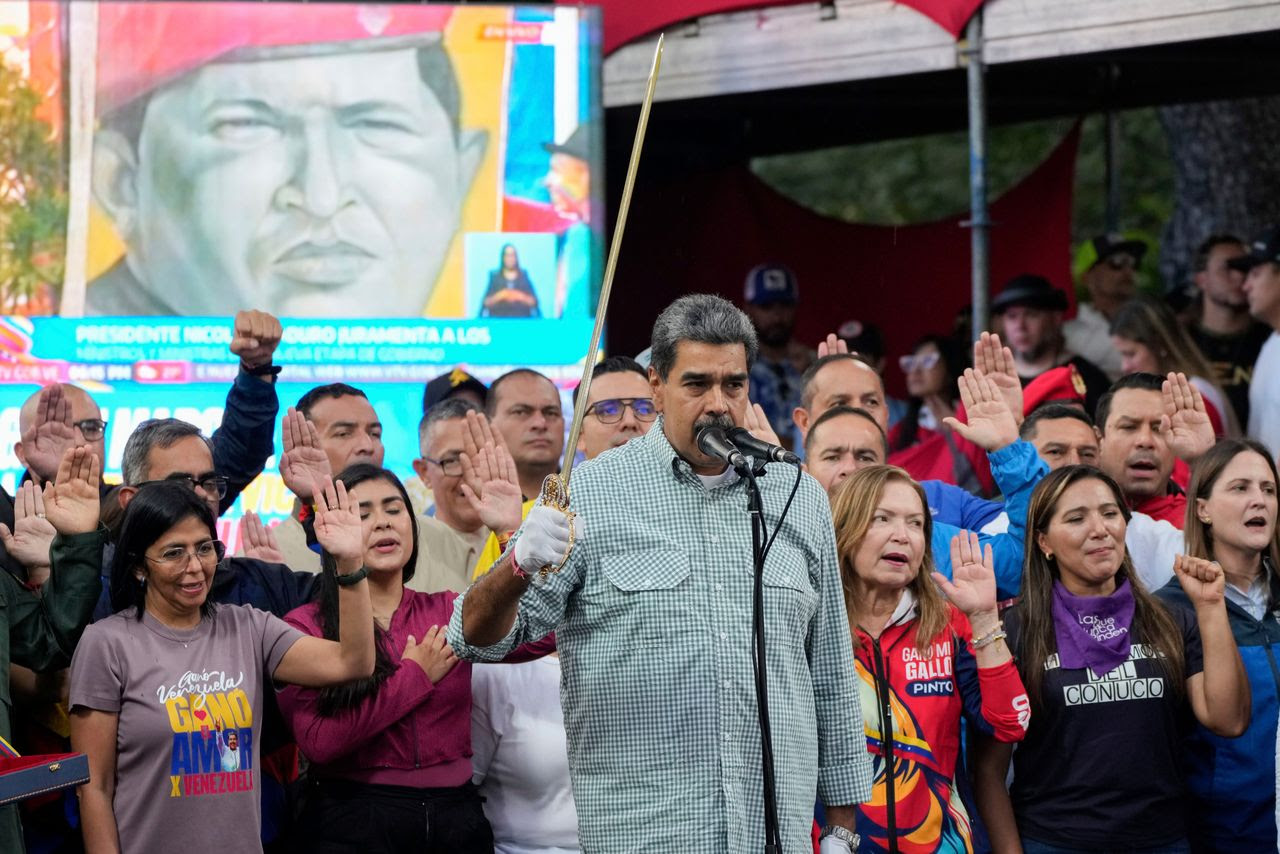 Venezuelan President Nicolás Maduro brandishes a sword Aug. 28 as his new cabinet takes the oath of office at the presidential palace in Caracas, Venezuela. (Ariana Cubillos/AP)