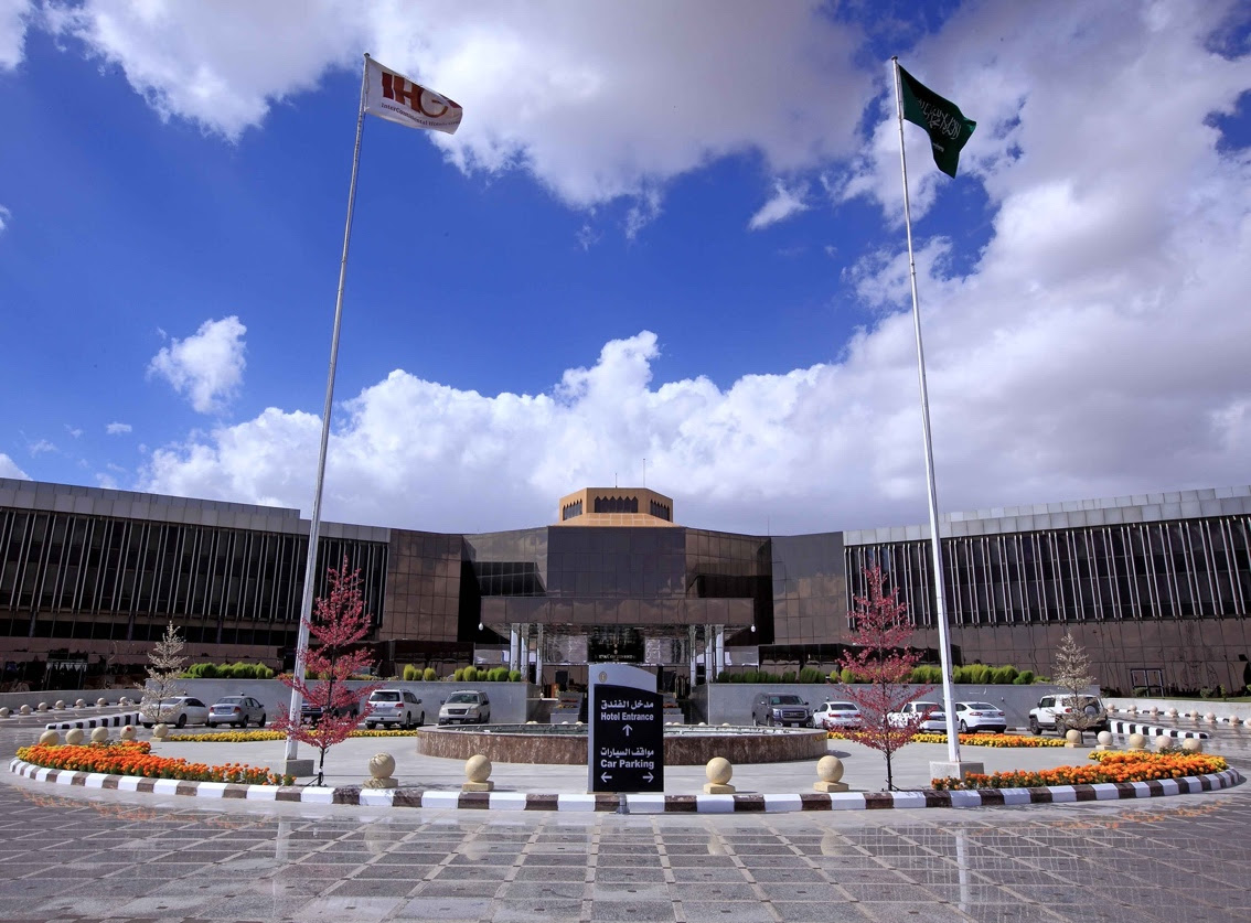 A building with flags in front of itDescription automatically generated