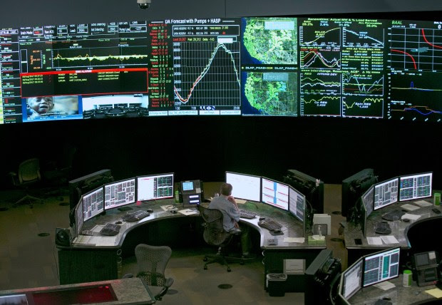 In this Aug. 18, 2017, file photo, electrical power flow and conditions are monitored at the California Independent System Operator grid control center in Folsom, Calif. (AP Photo/Rich Pedroncelli, File)