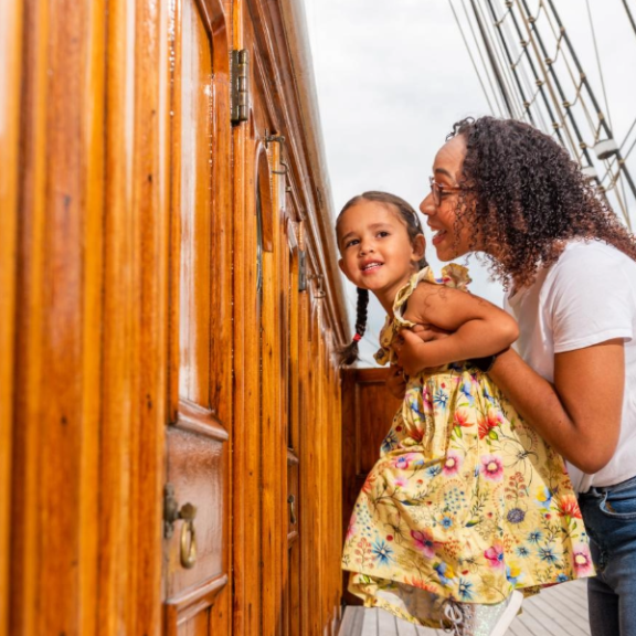 Woman holding her daughter on board Cutty Sark