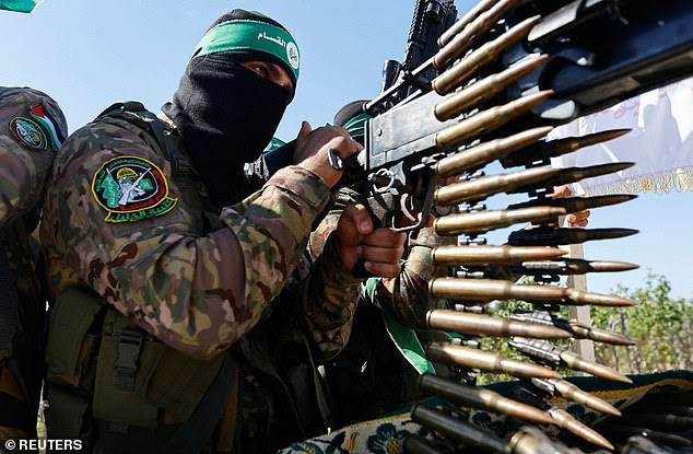 A Palestinian terrorist from the armed wing of Hamas takes part in a military parade to mark the anniversary of the 2014 war with Israel, near the border in the central Gaza Strip, on July 19, 2023