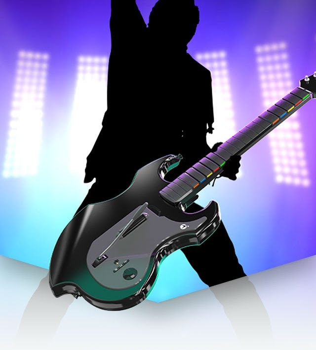 A silhouette of a person raising an arm in victory while holding the PDP RIFFMASTER Wireless Guitar on a stage with lights shining behind them.