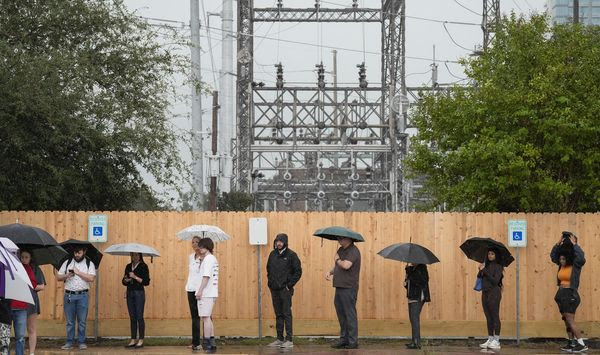 Rain pours down while voters are waiting in line to cast their vote on Election Day Tuesday, Nov. 5, 2024 at West Gray Multiservice Center in Houston. (Yi-Chin Lee/Houston Chronicle via AP)