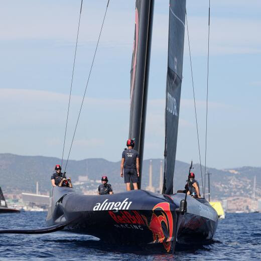 Switzerland's Alinghi Red Bull Racing crew members celebrate finishing ahead of Britain's Ineos Britannia during the 37th America's Cup-Luis Vuitton semi-final race, off the coast of Barcelona on September 16, 2024. (Photo by LLUIS GENE / AFP)