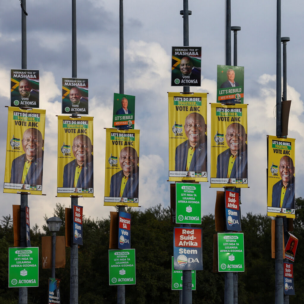 Election posters of different political parties are seen. 