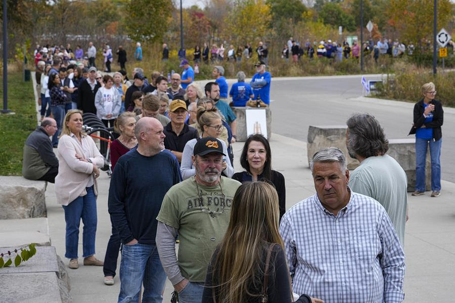 A line of people waiting to vote.