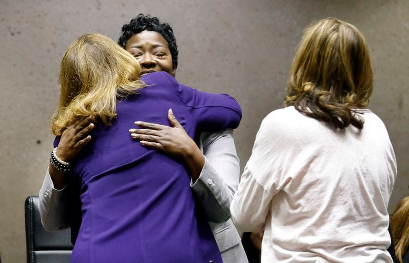 Deputy City Manager Kim Bizor Tolbert (facing) is congratulated by Dallas City council...