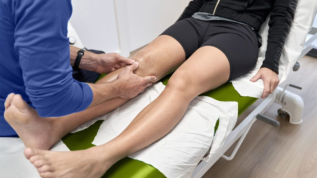 A doctor examining a knee