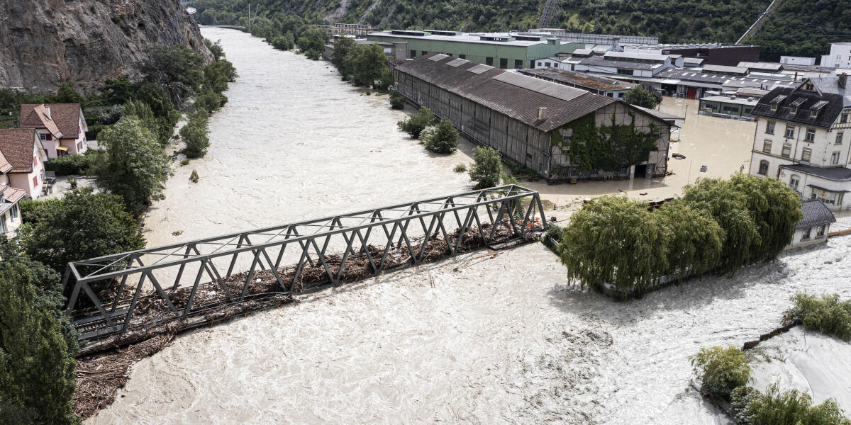 A view of the Rhone river, at right, and the Navizence river overflowing, following the storms that caused major flooding, in Chippis, Switzerland, Sunday, June 30, 2024. The Rhone river burst its banks in several areas of Valais canton, flooding a highway and a railway line. (Olivier Maire/Keystone via AP)