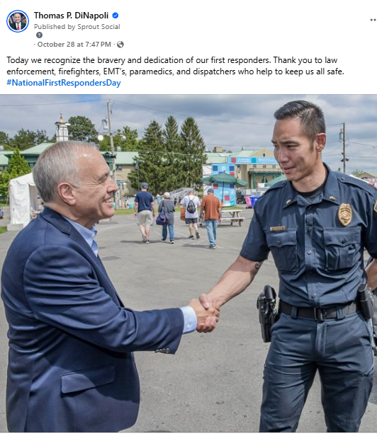 State Comptroller DiNapoli shaking police officer's hand