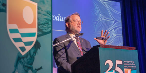 Senator Gary Peters speaking on stage. 